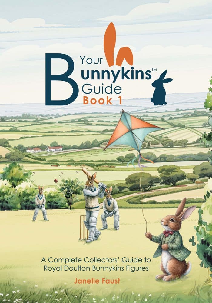 Illustration of anthropomorphic rabbits playing cricket and flying a kite in a countryside scene, the cover of 'Your Bunnykins Guide Book 1' by Janelle Faust.