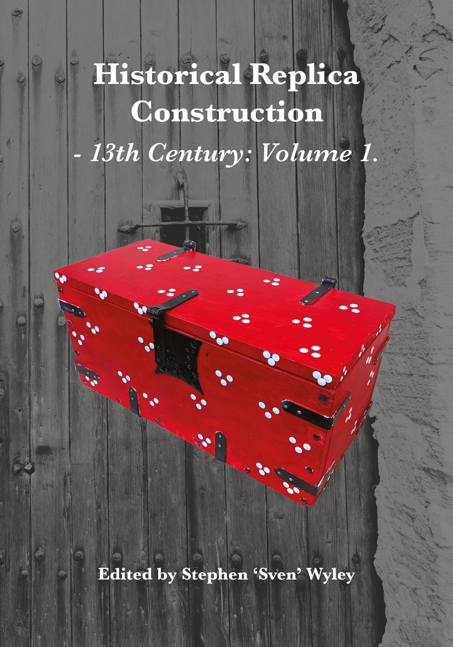 A vibrant red wooden chest with decorative white spots and black metal fixtures, set against a textured background of wooden and stone surfaces.